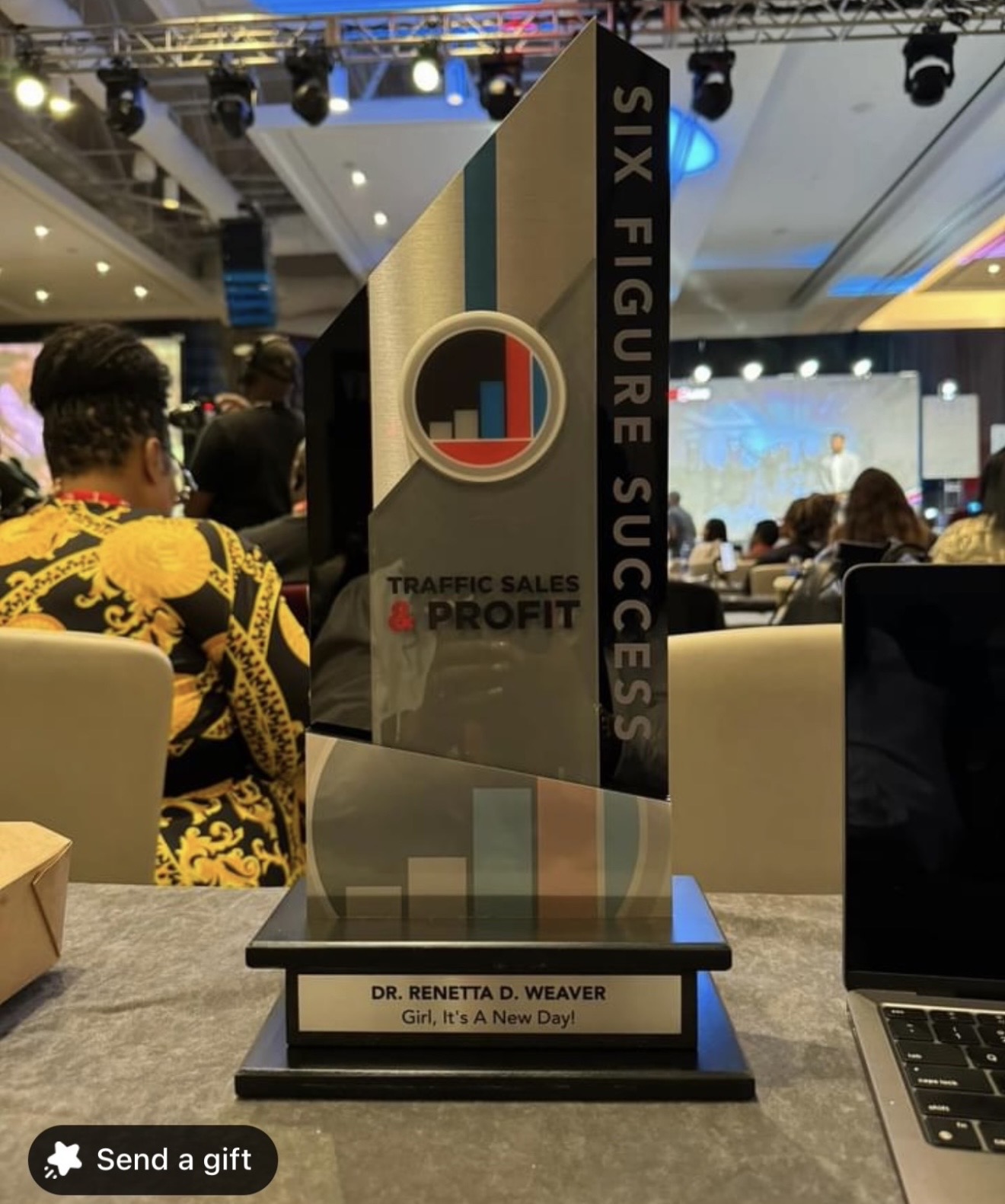 Six Figure Success award trophy inscribed to Dr. Renetta D. Weaver.